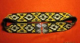 2"w x 31" long. Hand black, tan and silver beads. Mounted on black elastic w/snap closure.